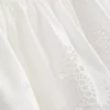 Pamutból készült, hímzett, peplumos szegélyű cami top
